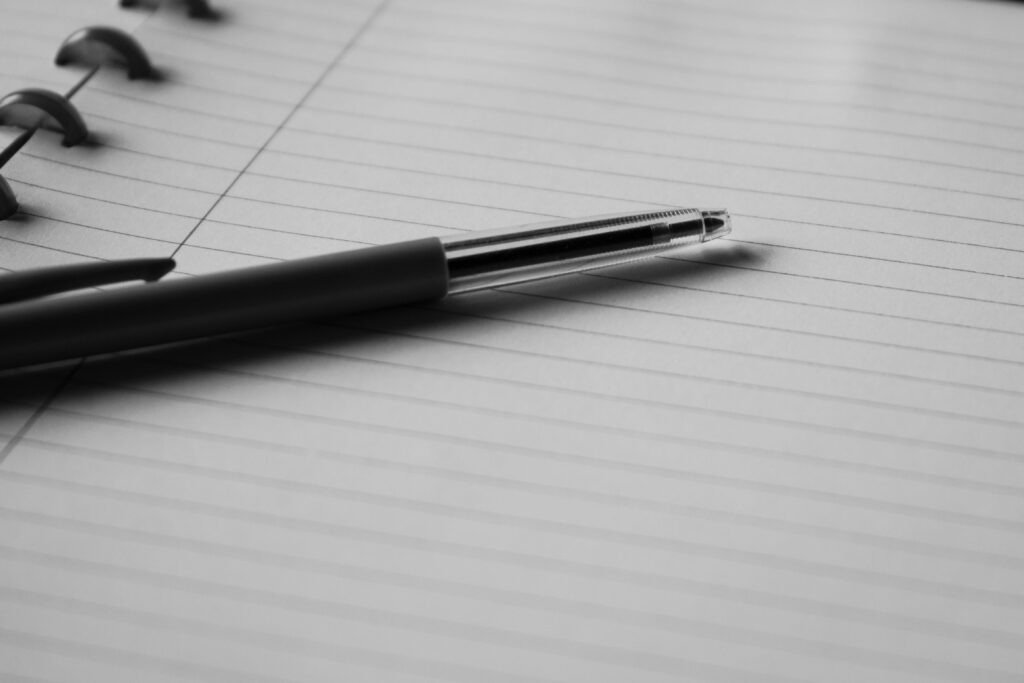 Blank notebook and pen ready for a GROW Model self-coaching exercise.
