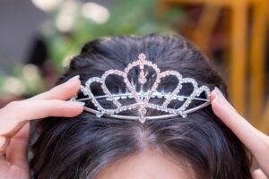 Close-up of a woman wearing a sparkling tiara illustrating the princess effect when life gives you more of what you expect